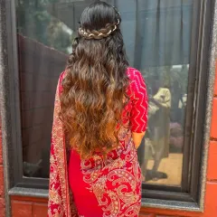 An absolutely timeless look for any wedding or special occasion. We created soft, flowing waves and a delicate crown braid for a romantic and elegant half-up hairstyle that perfectly complements her traditional attire.