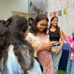 Candid moments of connection and friendship at our workshop. Our community is built on shared laughter and mutual support.