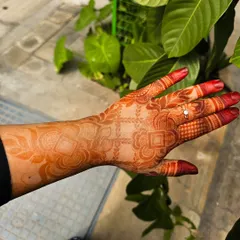 A lovely orange-red stain developing a few hours after paste removal. The design features a mix of geometric checks and delicate floral work on the forearm.