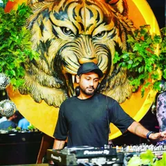 In the zone at Badmaash, with their iconic tiger mural behind me. This is my command center, where I blend Bollywood hits and commercial bangers.