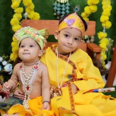 Two brothers dressed as little Krishnas for a festive photoshoot. Sibling sessions during festivals are a wonderful way to create lasting memories.