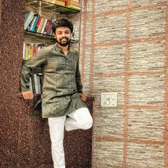 A simple photo in my home, dressed in traditional Indian wear. This is me, grounded in my roots, surrounded by my books and my space.
