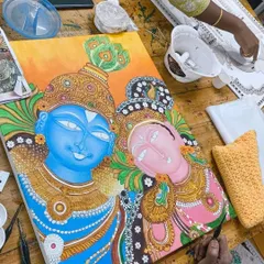 A stunning Kerala Mural painting of Radha and Krishna in progress. This art form is famous for its bold colors and divine figures.