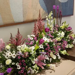 A lush and textural floral arrangement. We combined tulips, astilbe, and daisies in shades of pink, purple, and white to create a beautiful, sprawling centerpiece that feels both wild and curated.
