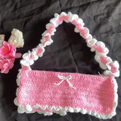 Front view of the handmade pink ruffle bag. The little white bow in the center is my favorite part and completes the coquette vibe.