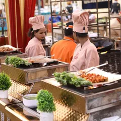My live grill stations are perfect for adding sizzle to any event. Here, my female chefs in pink uniforms prepare delicious grilled appetizers, offering guests a fresh and interactive dining experience.