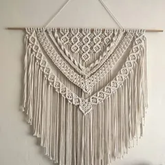 A classic layered macrame wall hanging with multiple tiers of detailed patterns. This timeless design is versatile and works well in a bedroom, living room, or entryway.