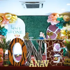 Anav's "Wild One" birthday was a jungle extravaganza. We used a greenery wall, animal print "ONE" letters, plush animal toys, and a colourful balloon garland to create a fun and friendly safari atmosphere.