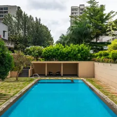 Here you can see how the landscape design provides a natural buffer between the residential blocks and the shared pool area. The sunken pool deck and raised planters create a sense of enclosure and tranquility, making it feel like a private resort.