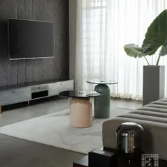 A modern living room project featuring a custom media unit, a channel-tufted sofa, and unique coffee tables. The dark, textured wallcovering adds depth and drama to the space.