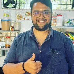 A photo of me, Vinay, in our kitchen. I am grateful to carry forward my father's legacy and am committed to serving you the same quality and taste that you have come to expect from us.