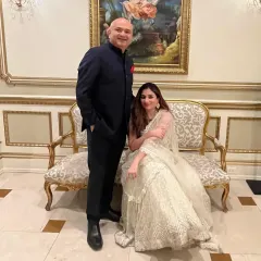 A suit that speaks for itself. My client, pictured with his wife, wears a custom navy bandhgala, crafted with precision for a look of timeless elegance.