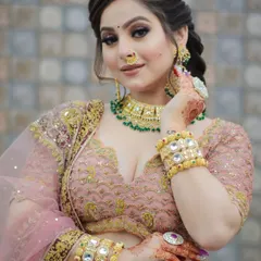This client is ready for a party with her glamorous makeup. The look features a defined smokey eye and a soft pink lip, paired with a beautiful braided hairstyle.