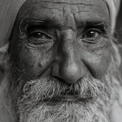 This close up portrait reveals a slice of life that might otherwise pass unnoticed. The light catches the depth in his eyes, showing a universal humanism that connects us all, captured in Bharatpur.