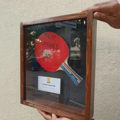 A look at the TT paddle shadow box from the side, showing the depth of the wooden frame and the glass front that protects the special memento inside.