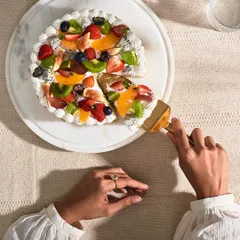 Here is my Fresh Fruit Gateau, ready to be served. This cake is made with a light vanilla sponge, creamy pastry cream, and coated in almond flakes, then topped with a vibrant mix of exotic fruits for a refreshing finish.