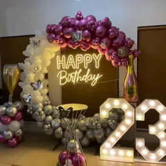 I love this modern and stylish color combination. For this 23rd birthday, I used a mix of purple, silver, and white balloons on a ring arch, accented with butterfly details, a champagne bottle foil balloon, and marquee numbers.
