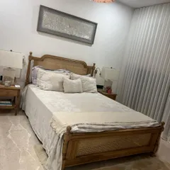 This French-style bed, crafted from oak with cane panels on the headboard and footboard, was a custom project for a client. The turned legs and classic silhouette add a touch of European elegance.