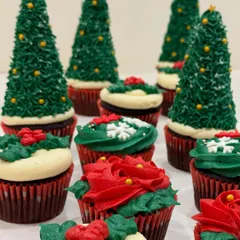 My Belgian chocolate cupcakes get a festive makeover for Christmas. Here you can see them decorated as Christmas trees, wreaths, and poinsettias with my signature vanilla buttercream.