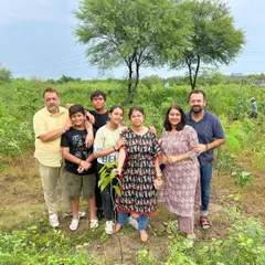 A family proudly stands with the sapling they just planted. We encourage families to join our drives, as it creates a lasting bond with the tree and the environment.