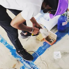 Attention to detail is crucial. Here, a member of our team is carefully preparing the smaller electronic components and connectors before they are integrated into the main access control panel.