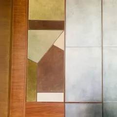 A detail of a custom wall unit, where panels of leather in earthy tones are combined with wood and metal. This exploration of materiality creates a distilled sensory richness and a quiet, tactile presence in this contemporary home.