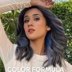 This shot captures the full beauty of the ash, lilac, and blue blend. The model's pose shows off the color in natural light, highlighting the cool, smokey finish.