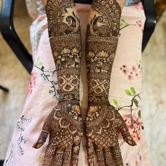 This full-arm design is packed with traditional elements, including rows of elephants, blooming lotuses, and majestic peacocks, all framed by intricate borders.