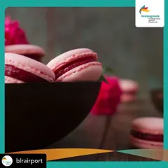 A close-up of our vibrant pink macarons, filled with a luscious fruit compote. The colour comes from natural sources, reflecting the real ingredients we use in our fillings.