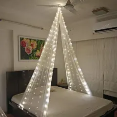 A simple yet beautiful bedroom transformation. I used a canopy of sheer fabric with fairy lights to create a dreamy and romantic space for a special occasion at home.