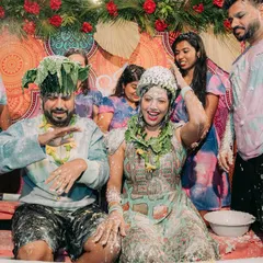 A candid moment of pure fun during a Haldi ceremony, where the couple gets playfully drenched by their friends and family.