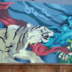 Here you can see the tiger from the Mysore mural interacting with the central figure. We designed the composition so that each element flows into the next, telling a cohesive story across the entire wall.