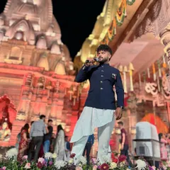 Standing on a stage adorned with flowers, with the grand temple setup behind me. A truly divine setting.