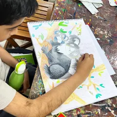 A young artist deeply focused on his koala drawing. Our classes help kids develop patience and attention to detail, seeing a project through from sketch to finished piece.