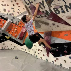 A powerful move during a "Climb Like a Woman" session at our gym. We host inclusive events to encourage everyone to join the sport and conquer challenging routes.