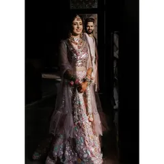 A portrait using dramatic light and shadow to create a sense of intimacy and artistry. The bride shines in the light while her groom stands supportively in the background, a beautiful metaphor for their partnership.