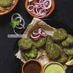 Hara Bhara Kebabs, made from a nutritious blend of spinach, peas, and potatoes. These pan-fried patties are a healthy and delicious vegetarian starter, seasoned with Indian spices and served with dipping sauces.