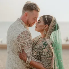 An intimate couple portrait from a beach wedding, capturing a quiet moment of connection against the serene backdrop of the sea. We specialize in finding these beautiful, personal moments amidst the celebration.