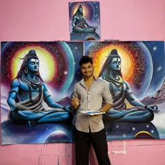 A photo of me with my brushes and palette next to the completed cosmic Shiva commissions.