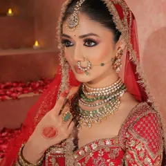 A close-up of our queenly bride, with her dupatta framing her face. The focus is on her mesmerizing eyes, defined with kohl and a touch of shimmer, and the intricate details of her jewelry.