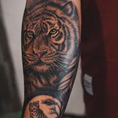 A tiger tattoo represents silent strength and courage. For this piece, I focused on creating hyper-realistic fur texture and piercing green eyes that hold your gaze. The deep, layered shading gives it a powerful 3D effect, making it a bold statement on the forearm.