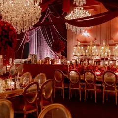 We drenched this Sangeet night in opulent shades of red, using rich velvet draping and dramatic lighting to create a royal, majestic ambiance. The combination of crystal chandeliers and hundreds of candles provided a warm, intimate glow for an evening of celebration.