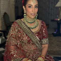 A portrait of my stunning bride Ayushi. Her makeup features a warm, bronzed contour, subtly smoked-out eyes, and a soft matte lip, creating a look that is both traditional and effortlessly modern.