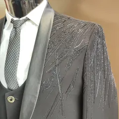 Another detailed shot of a designer suit, this time with grey-on-grey embroidery, showing the texture and craftsmanship of the beadwork.