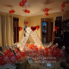 We make celebrations deeply personal by incorporating your memories into the decor. Here, we've hung cherished photos from balloons over a fairy-lit cabana, creating a beautiful and sentimental surprise for a birthday celebration in a living room.