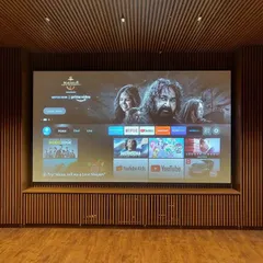A finished project where we integrated a large screen into a custom wood-slatted wall. The smart TV interface is up and running, ready for the client to enjoy their favorite streaming services.