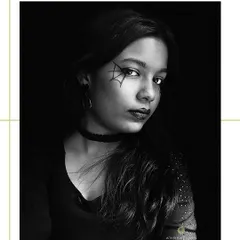 Spooky but chic. This black and white photo captures a dramatic Halloween look featuring a delicate spider-web eye makeup design.