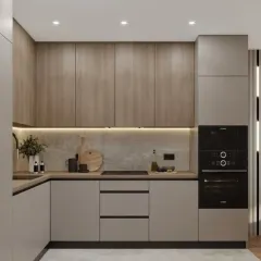 A compact L-shaped kitchen that feels warm and modern. We paired light grey lower cabinets with wood-grain upper cabinets and integrated a full-height unit for the oven, ensuring a clean look and efficient use of space.