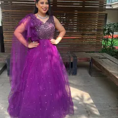 For a reception or sangeet, we can bring the drama. This full-glam look features a bold lip and defined eyes, paired with a stunning purple gown, perfect for an evening of celebration.