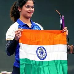 Manu Bhaker proudly holding the Indian tricolor after her historic bronze medal win at the Paris 2024 Olympics. Moments like these are the culmination of our dedicated Olympic shooting training program.